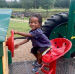 Child on playground tractor